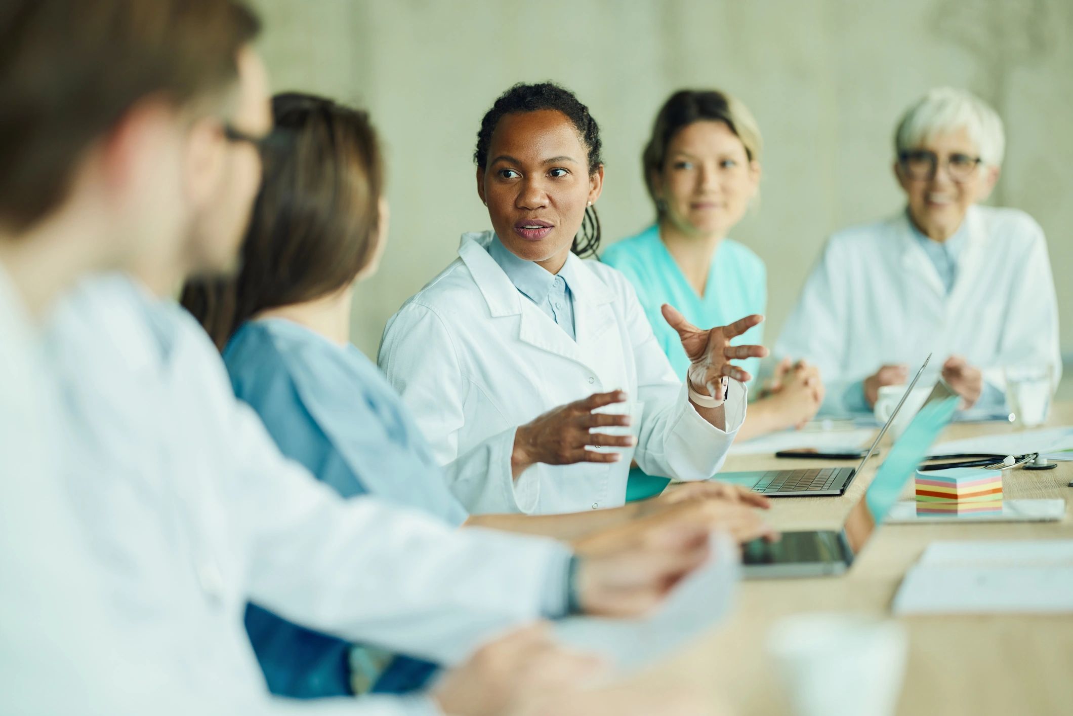 Healthcare professionals meeting to coordinate coverage and care services.