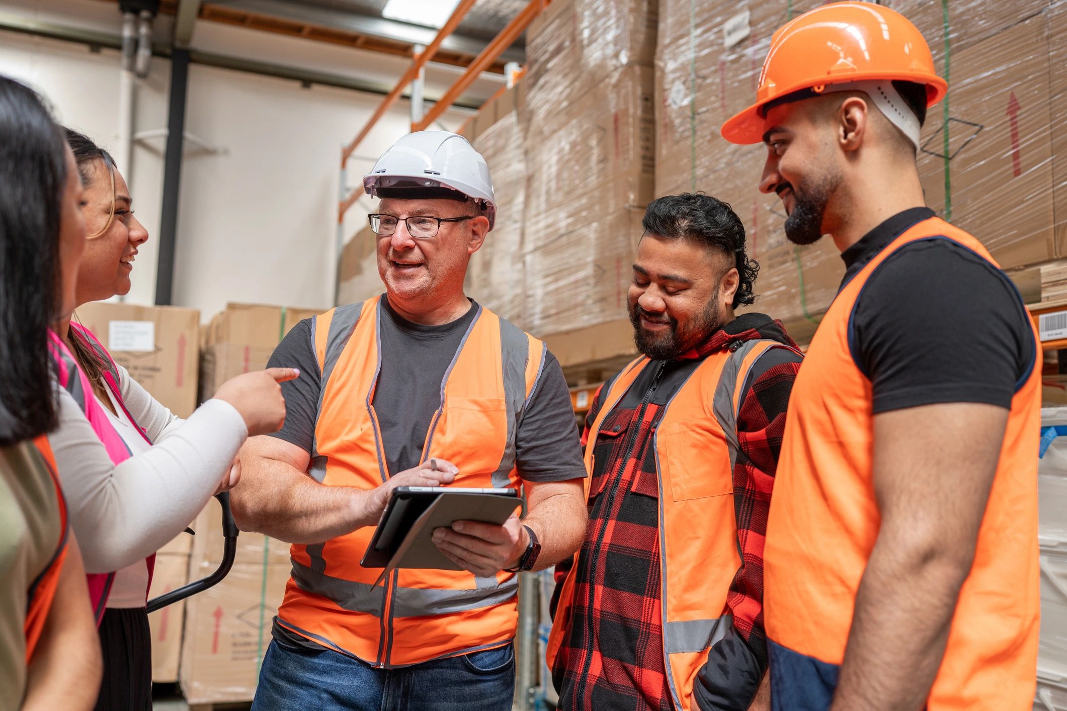 Operations team coordinating work using a tablet in a facility environment